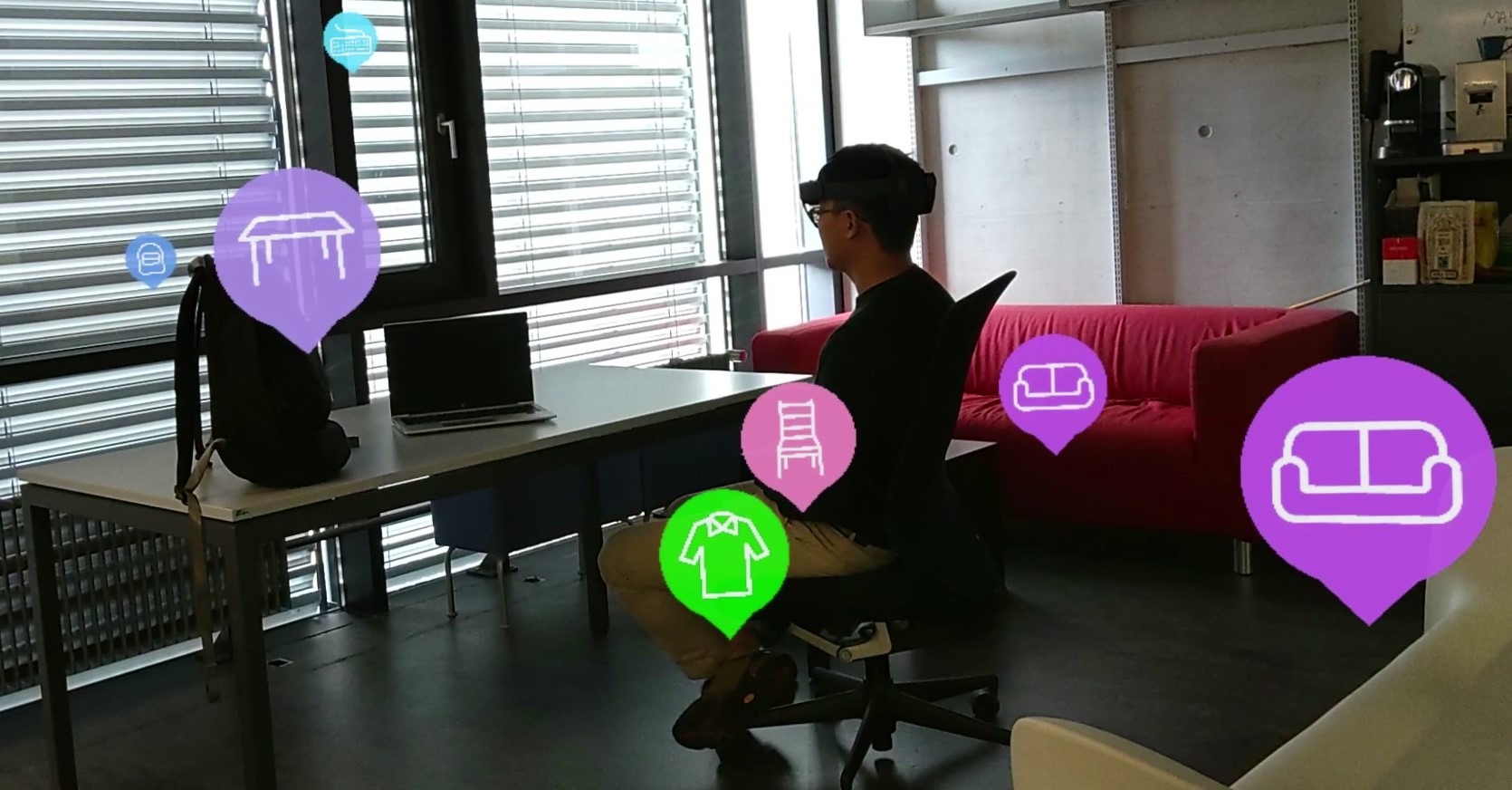 This figure presents first-person PoV footage from a HoloLens 2 headset of an indoor office setup with a person, a table, a laptop, chairs, and a sofa. Viusal icons are anchored to these objects and the icons illustrate the objects they correspond to.